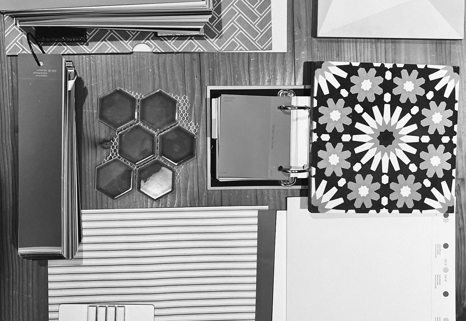 A finishes board of hex tile, patterned cement tile, paint fans and stripe samples
