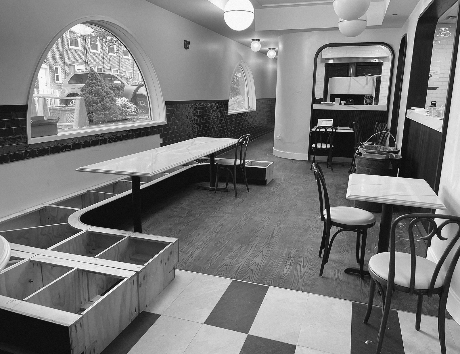 A dining room before opening, banquette frames still bare plywood