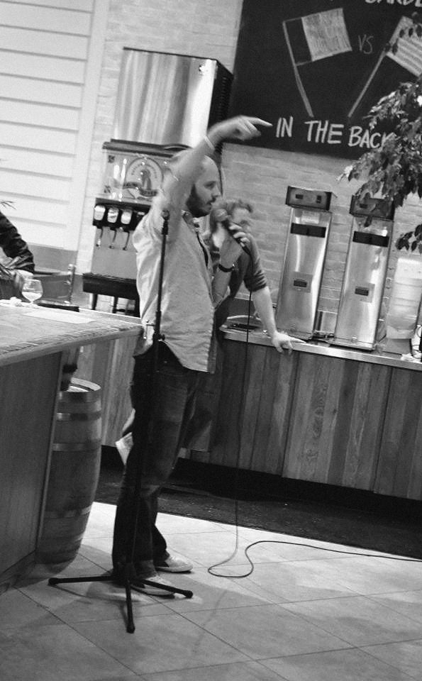 Dave on the mic at a beer garden bar