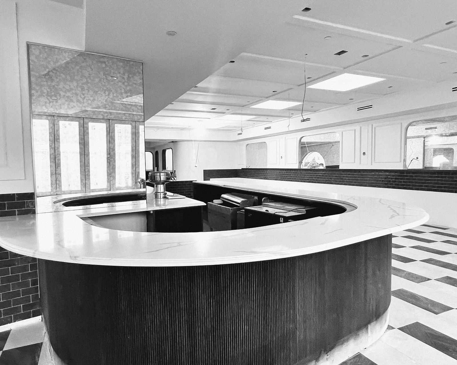 A finished curved bar with a white top, ready for service
